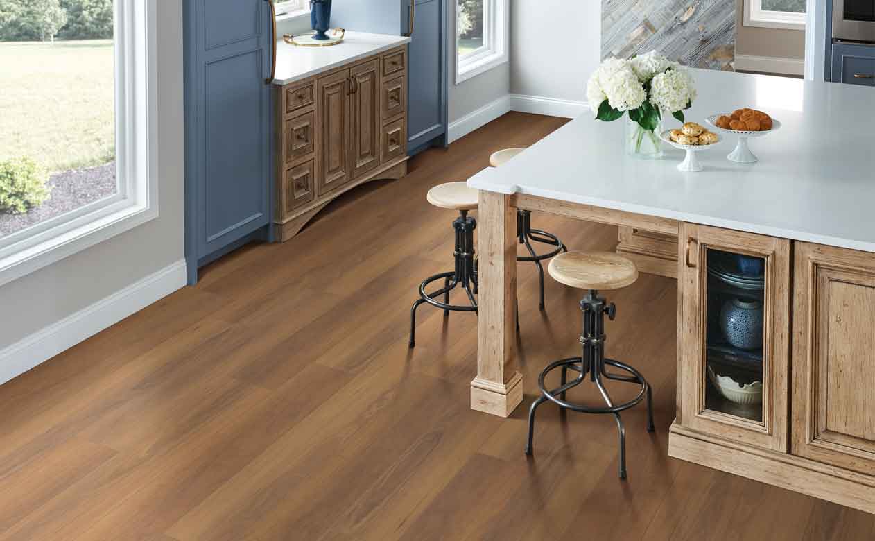 Wood look vinyl flooring in kitchen with wooden table and stools
